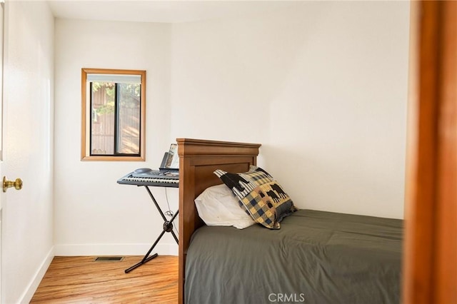 bedroom with wood-type flooring