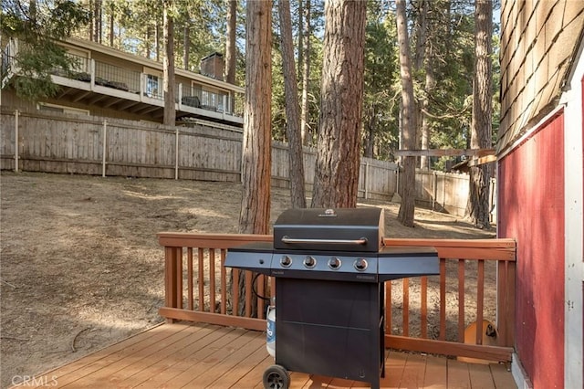 wooden deck featuring a grill