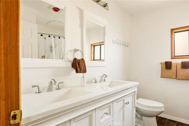 bathroom with vanity, wood-type flooring, and toilet