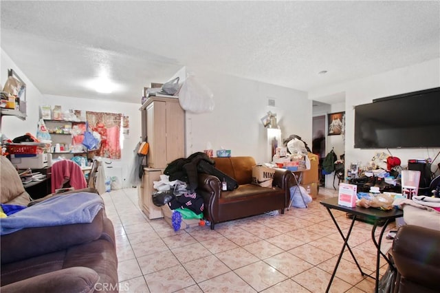 living room featuring a textured ceiling and light tile patterned flooring