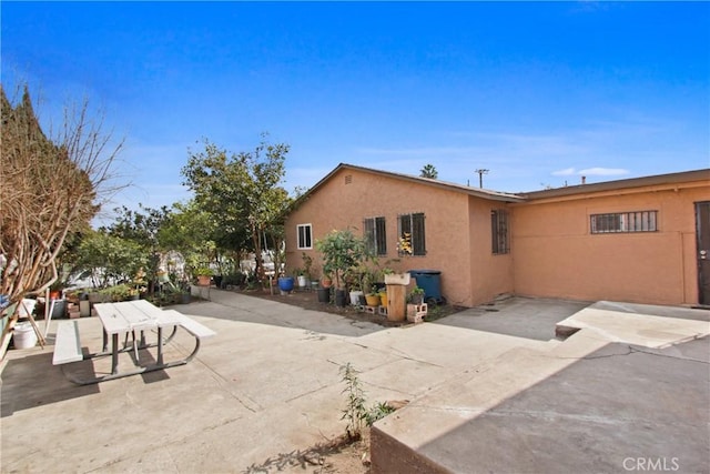 rear view of property featuring a patio