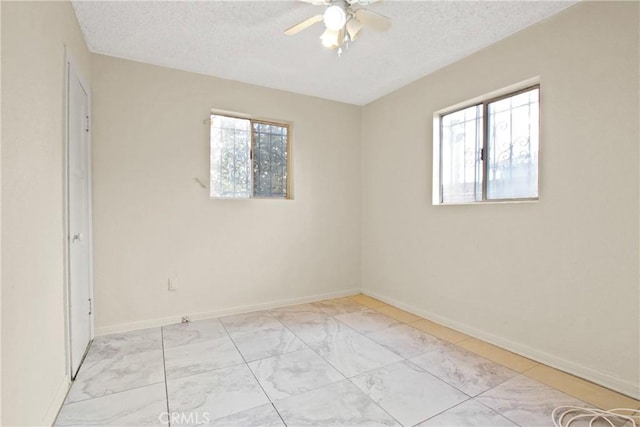 unfurnished room featuring ceiling fan and a textured ceiling