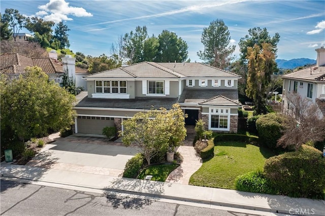 view of front of house featuring a front lawn and a garage