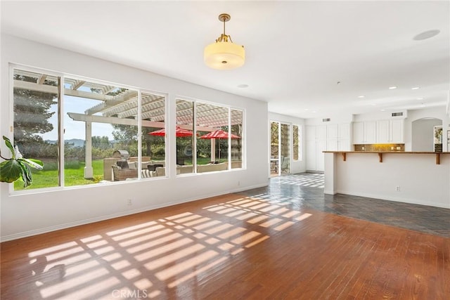 unfurnished living room featuring dark wood-type flooring