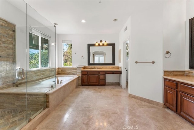 bathroom featuring shower with separate bathtub and vanity