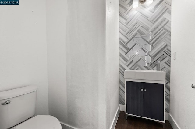 bathroom with vanity, hardwood / wood-style floors, and toilet