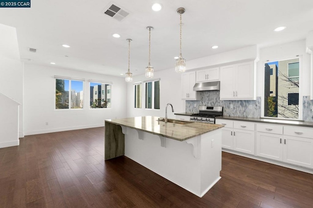 kitchen featuring pendant lighting, sink, a kitchen island with sink, white cabinetry, and stainless steel range with gas cooktop