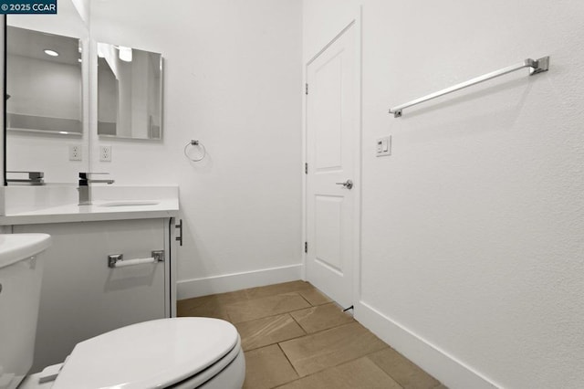 bathroom with vanity, tile patterned floors, and toilet