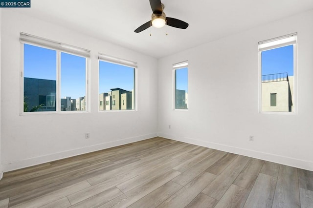 spare room with ceiling fan and light hardwood / wood-style floors