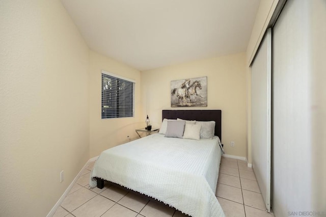 bedroom featuring a closet and light tile patterned floors