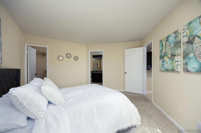 carpeted bedroom featuring a spacious closet and a closet