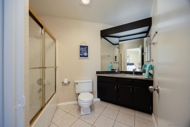 full bathroom with vanity, combined bath / shower with glass door, tile patterned floors, and toilet