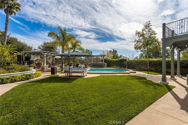 view of yard with a fenced in pool, fence, a balcony, and a pergola