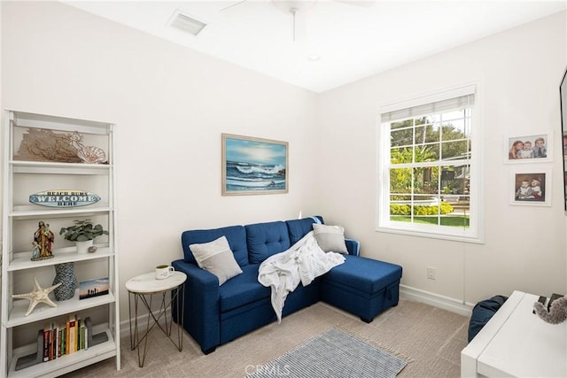 sitting room featuring light carpet, ceiling fan, visible vents, and baseboards