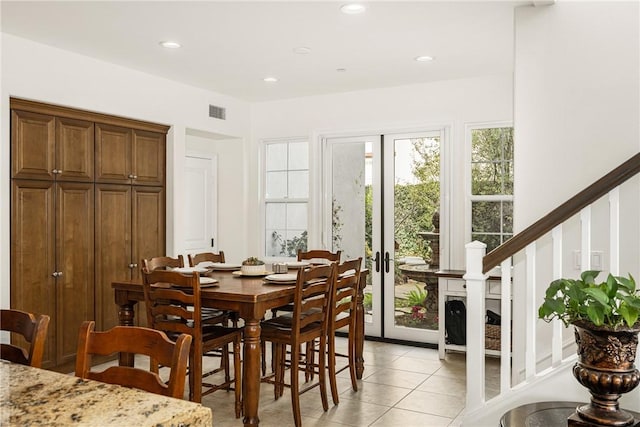 dining space with light tile patterned floors, visible vents, stairs, french doors, and recessed lighting