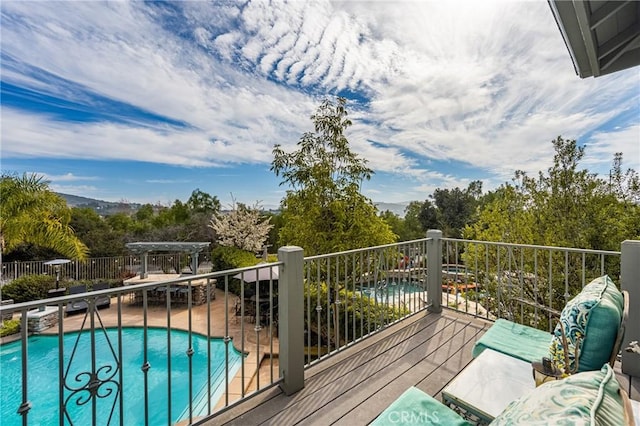 deck with a fenced in pool and a pergola