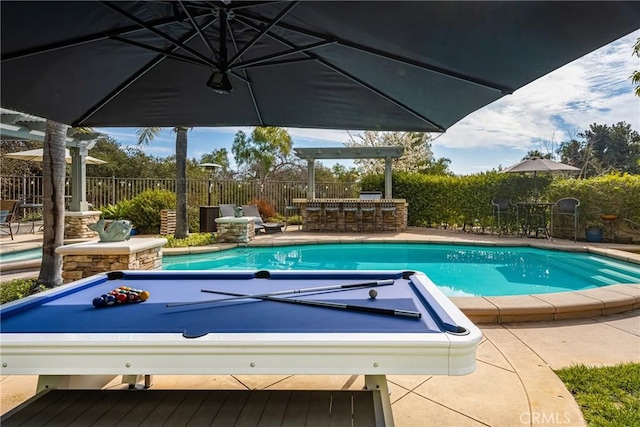 view of swimming pool with a fenced in pool, fence private yard, a patio area, and outdoor dry bar