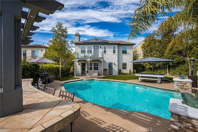 outdoor pool with a patio area