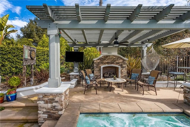 view of patio with fence, an outdoor stone fireplace, an outdoor pool, and a pergola