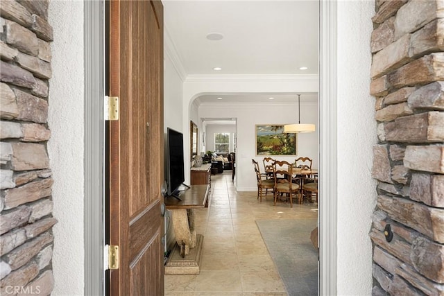 entrance foyer featuring arched walkways, light tile patterned floors, recessed lighting, and crown molding