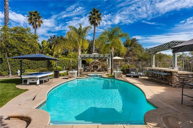 view of swimming pool with a patio, fence, outdoor dry bar, and a pergola