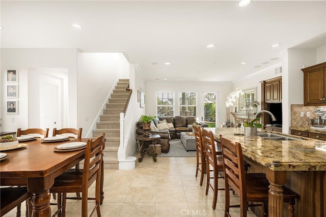 dining room with light tile patterned floors, stairs, ornamental molding, and recessed lighting