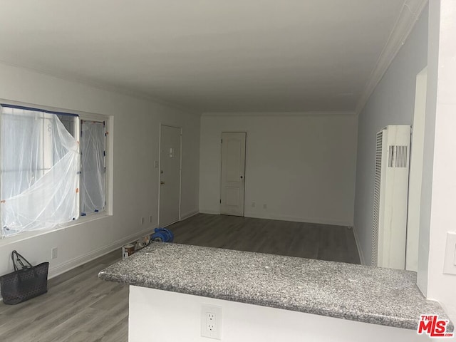 empty room featuring ornamental molding, radiator, and hardwood / wood-style floors