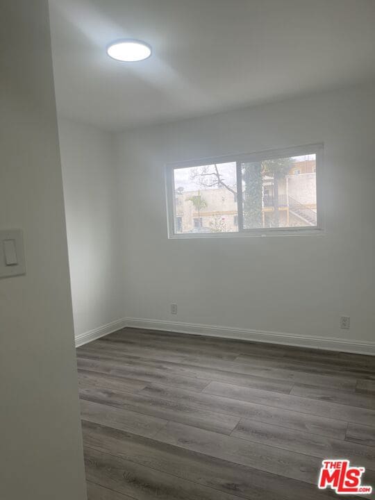 empty room featuring dark wood-type flooring