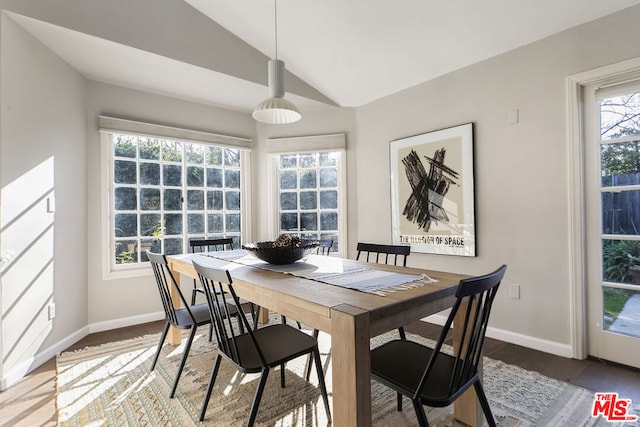 dining room featuring lofted ceiling and hardwood / wood-style floors