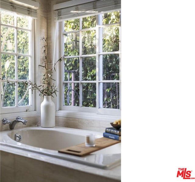 bathroom featuring a relaxing tiled tub