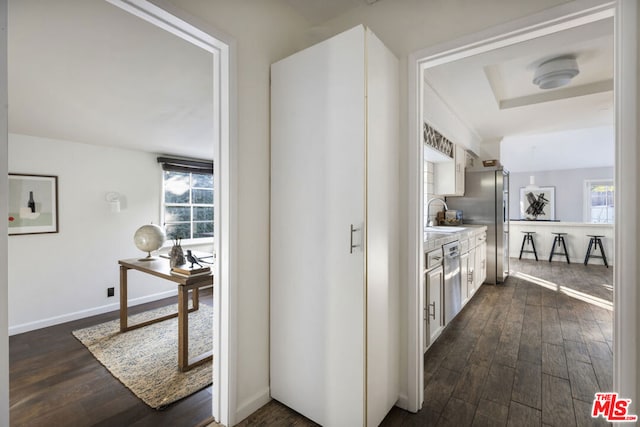 kitchen featuring dark wood-type flooring, stainless steel appliances, and white cabinets