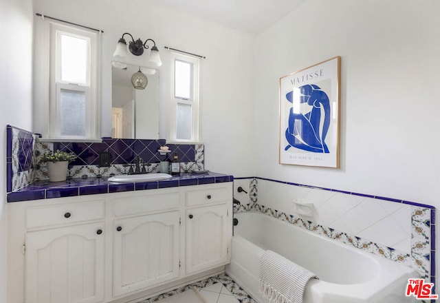 bathroom featuring vanity, a bath, and backsplash