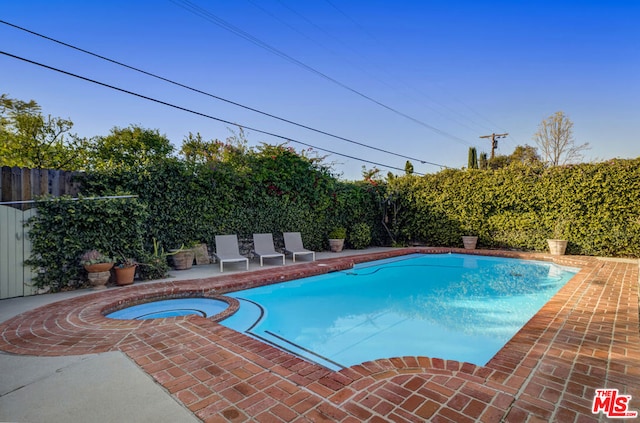 view of pool with an in ground hot tub and a patio