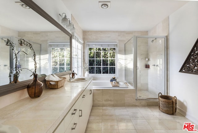 bathroom with vanity, tile patterned flooring, and separate shower and tub