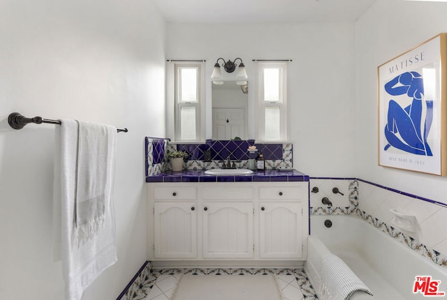 bathroom featuring a tub to relax in, decorative backsplash, and vanity