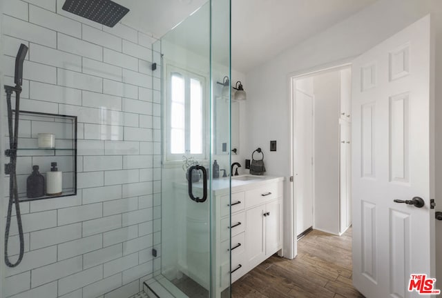 bathroom with vanity, a shower with door, and hardwood / wood-style floors