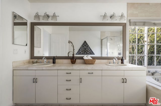 bathroom with vanity and separate shower and tub