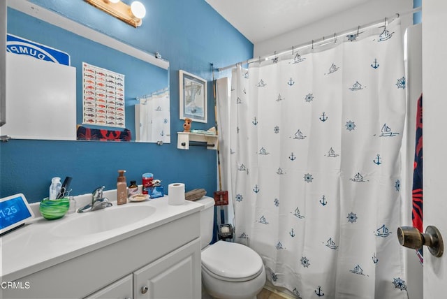 bathroom featuring vanity, toilet, and a shower with shower curtain