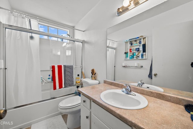 full bathroom with enclosed tub / shower combo, vanity, and toilet