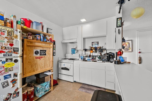 kitchen featuring white cabinetry, white appliances, and sink