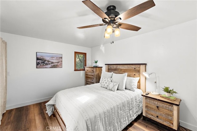 bedroom with dark hardwood / wood-style floors and ceiling fan