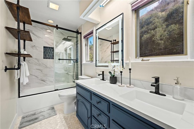 full bathroom with vanity, shower / bath combination with glass door, and toilet