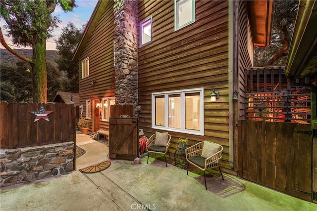 back house at dusk with a patio area