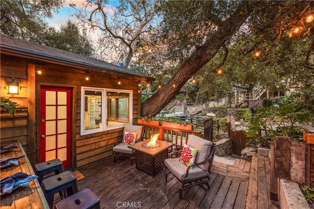 deck at dusk with a fire pit