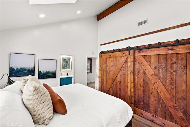 bedroom with ensuite bathroom, high vaulted ceiling, and beam ceiling