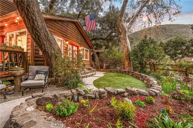 yard at dusk with a patio area