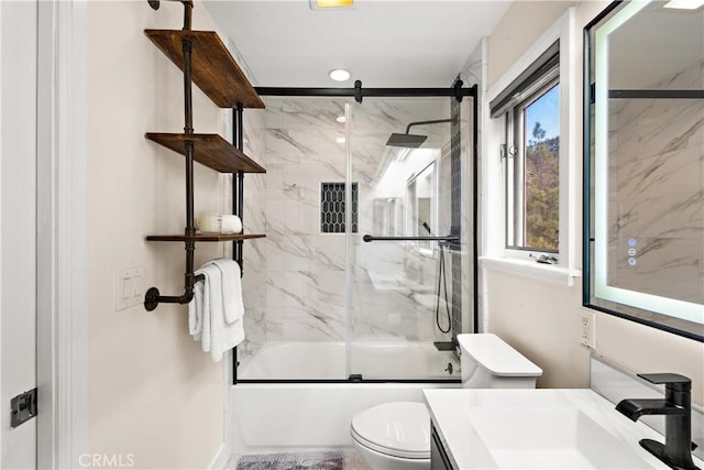 full bathroom featuring enclosed tub / shower combo, vanity, and toilet