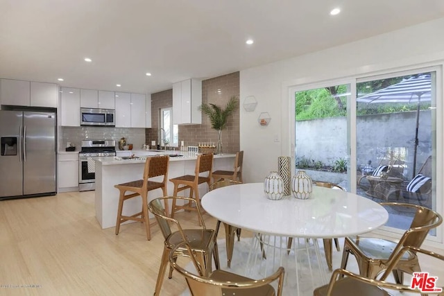 dining area featuring light wood-type flooring