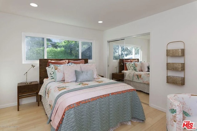 bedroom featuring light wood-type flooring and a closet