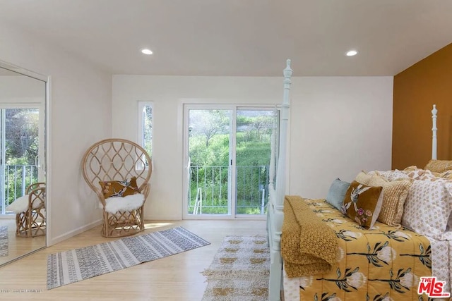 bedroom with access to exterior and light hardwood / wood-style floors